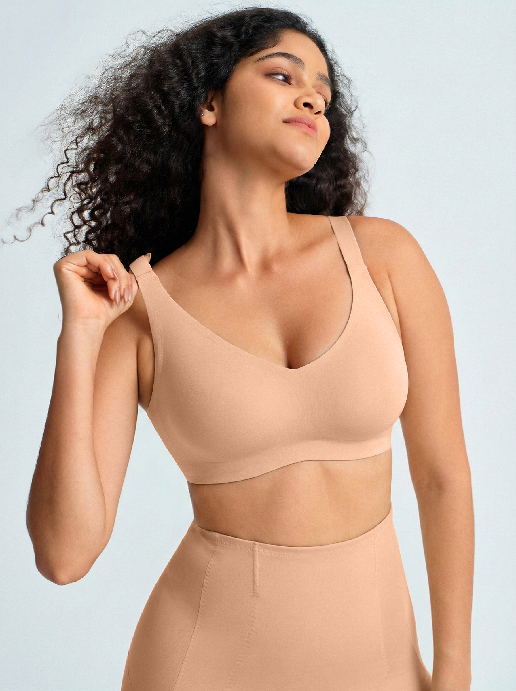 Woman wearing a nude wireless comfort full coverage bra. The brand is Baerely who supports wireless bras with support and lift.