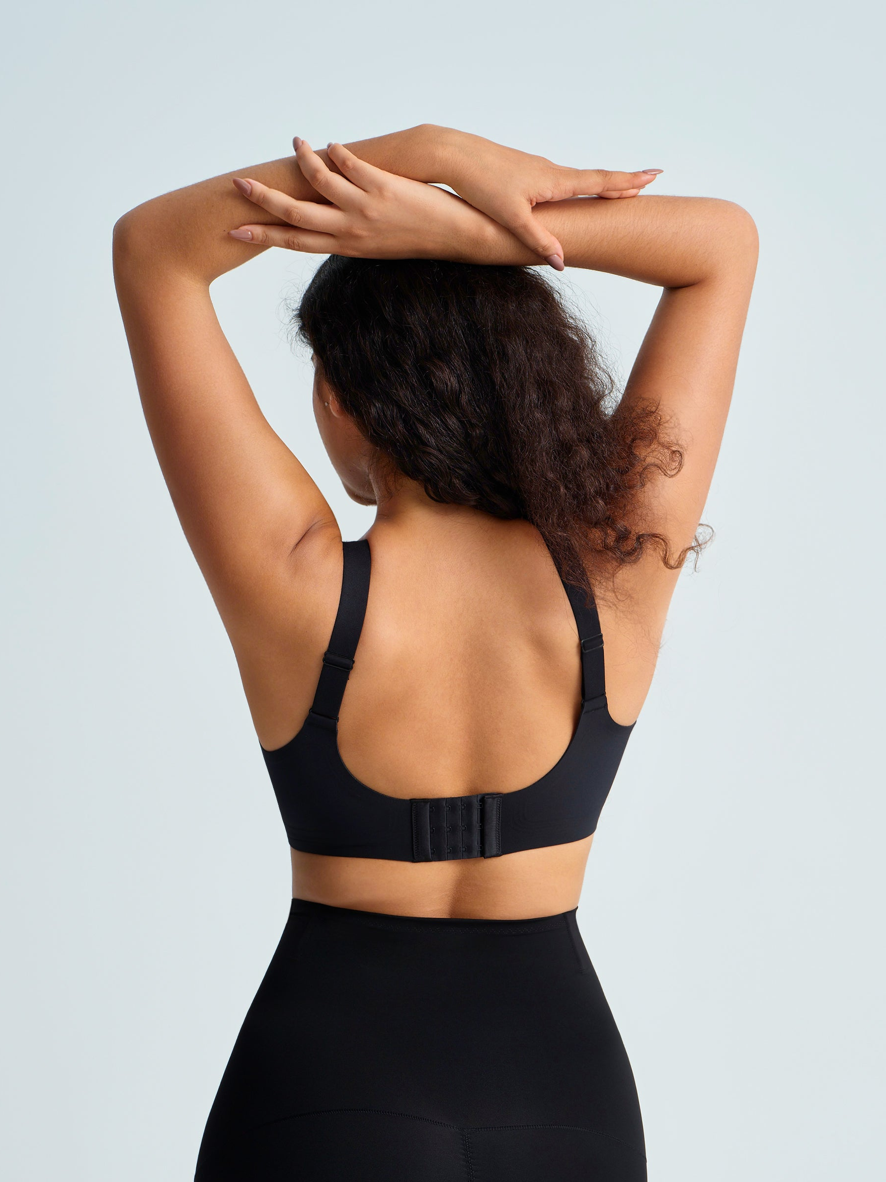Woman wearing a black wireless seamless bra. The brand is Baerely who supports wireless seamless push up no underwire full coverage bra.