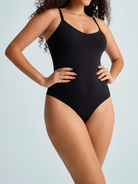 Woman wearing a black waist cinching bodysuit. The brand is Baerely who supports shaping bodysuits with tummy control & shapermint firm tummy control shapewear & body shaper tummy control.