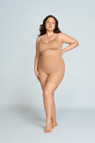 Woman wearing a nude wireless comfort full coverage bra. The brand is Baerely who supports wireless bras with support and lift.