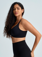 Woman wearing a black wireless full coverage bra. The brand is Baerely who supports wireless full coverage bras for women.