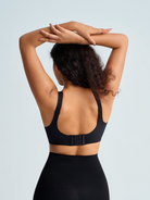 Woman wearing a black wireless seamless bra. The brand is Baerely who supports wireless seamless push up no underwire full coverage bra.